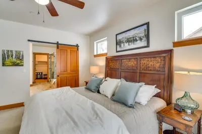 a bedroom with a large bed with a wooden headboard at Family Home with Hot Tub 6 Mi to Winter Park Resort in Fraser