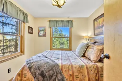 a bedroom with a bed and a window at Family & Dog Welcoming Lodge with Hot Tub & Games in Nederland