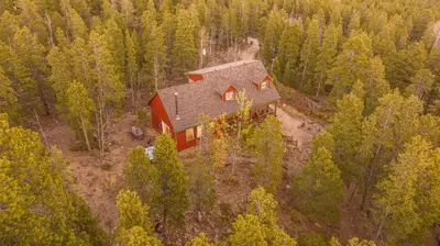 an aerial view of a house in the woods at Family & Dog Welcoming Lodge with Hot Tub & Games in Nederland