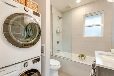 a bathroom with a washer and dryer at Hot Tub, Fire Pits Ideally Located Denver Home! in Denver