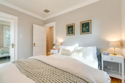 a white bedroom with a bed and a window at Hot Tub, Fire Pits Ideally Located Denver Home! in Denver