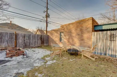 a backyard with two picnic tables and a brick building at Hot Tub, Fire Pits Ideally Located Denver Home! in Denver