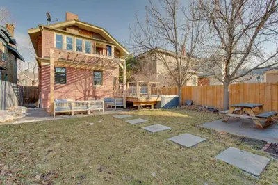 a backyard with a picnic table and a house at Hot Tub, Fire Pits Ideally Located Denver Home! in Denver