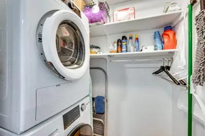 a washer and dryer in a small room at Cozy Westminster Condo 14 Mi to Downtown Denver! in Westminster