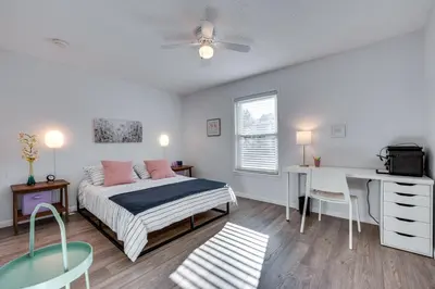 a bedroom with a bed and a desk and a table at Cozy Westminster Condo 14 Mi to Downtown Denver! in Westminster