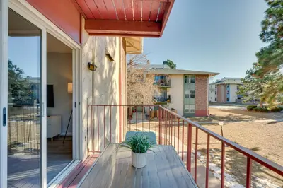 a house with a balcony with a potted plant on it at Cozy Westminster Condo 14 Mi to Downtown Denver! in Westminster