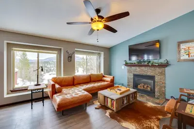 a living room with a couch and a fireplace at 13 Mi to Winter Park Mtn-View Granby Cabin in Granby