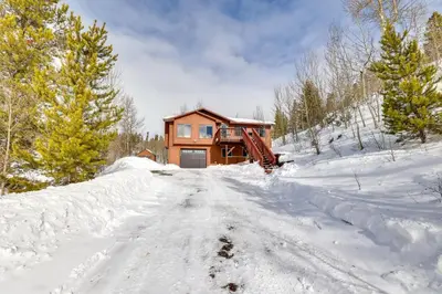 a house on a snow covered road in the snow at 13 Mi to Winter Park Mtn-View Granby Cabin in Granby