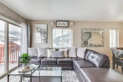 a living room with a leather couch and a table at 5 Mi to Keystone Resort Mountain-View Townhome! in Dillon