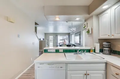 a kitchen with white cabinets and a sink at 5 Mi to Keystone Resort Mountain-View Townhome! in Dillon