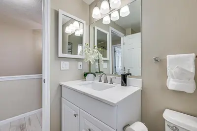 a white bathroom with a sink and a mirror at 5 Mi to Keystone Resort Mountain-View Townhome! in Dillon