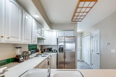 a kitchen with white cabinets and a stainless steel refrigerator at 5 Mi to Keystone Resort Mountain-View Townhome! in Dillon