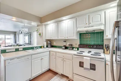 a white kitchen with white cabinets and appliances at 5 Mi to Keystone Resort Mountain-View Townhome! in Dillon