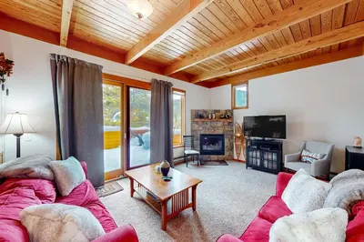 a living room with two couches and a tv at Lake to Mountain in Keystone