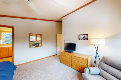a living room with a couch and a television at Lake to Mountain in Keystone