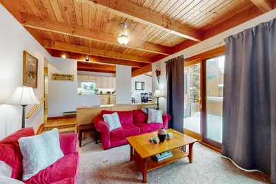 a living room with two red couches and a table at Lake to Mountain in Keystone