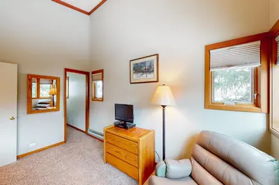 a living room with a couch and a television at Lake to Mountain in Keystone