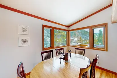 a dining room with a wooden table and chairs at Lake to Mountain in Keystone