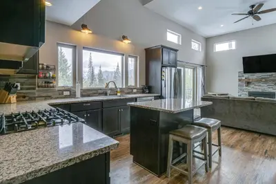 a kitchen with a sink and a stove top oven at Hike and Ski Grand Lake Cabin with Mtn-View Deck in Grand Lake