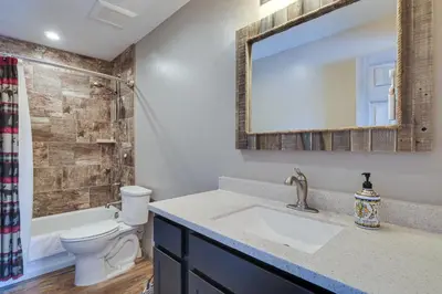 a bathroom with a sink and a toilet and a mirror at Hike and Ski Grand Lake Cabin with Mtn-View Deck in Grand Lake
