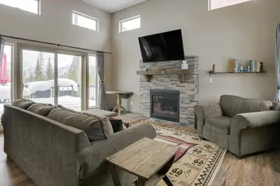 a living room with a couch and a fireplace at Hike and Ski Grand Lake Cabin with Mtn-View Deck in Grand Lake