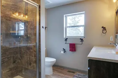 a bathroom with a shower and a toilet at Hike and Ski Grand Lake Cabin with Mtn-View Deck in Grand Lake