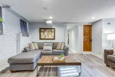 a living room with a couch and a coffee table at 1 Mi to Coors Field Cozy Denver Studio with Patio! in Denver