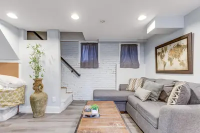 a living room with a couch and a table at 1 Mi to Coors Field Cozy Denver Studio with Patio! in Denver