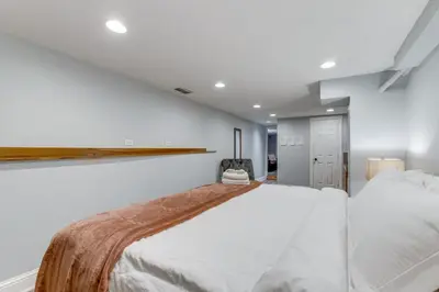 a bedroom with a large white bed in a room at 1 Mi to Coors Field Cozy Denver Studio with Patio! in Denver