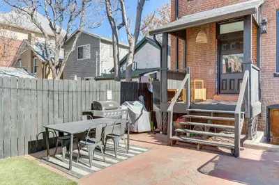 a patio with a table and chairs and a fence at 1 Mi to Coors Field Cozy Denver Studio with Patio! in Denver