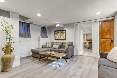 a living room with a couch and a table at 1 Mi to Coors Field Cozy Denver Studio with Patio! in Denver