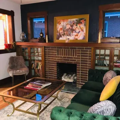 a living room with a couch and a fireplace at Charming 1920s Retreat Modern Kitchen 5 minutes to Dining and Med District in Denver