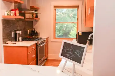 a kitchen with a chalkboard sign in a kitchen at Charming 1920s Retreat Modern Kitchen 5 minutes to Dining and Med District in Denver