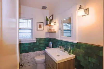 a bathroom with a sink and a toilet at Charming 1920s Retreat Modern Kitchen 5 minutes to Dining and Med District in Denver