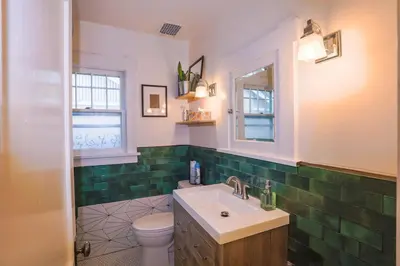 a bathroom with a sink and a toilet at Charming 1920s Retreat Modern Kitchen 5 minutes to Dining and Med District in Denver