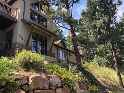 a house on top of a hill with trees at Morrison Colorado Mountain Getaway - Red Rocks in Morrison