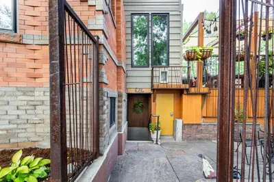 a house with an iron gate and a balcony at 2 Mi to Downtown Denver Stylish Gem with Fireplace! in Denver