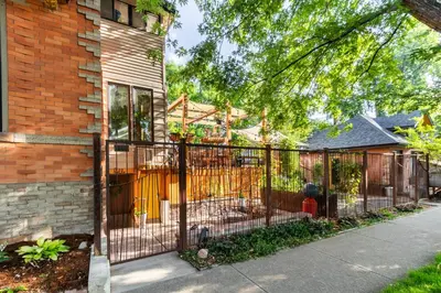 a wrought iron fence in front of a house at 2 Mi to Downtown Denver Stylish Gem with Fireplace! in Denver