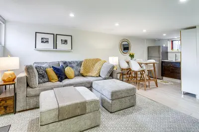 a living room with a couch and a table at 2 Mi to Downtown Denver Stylish Gem with Fireplace! in Denver