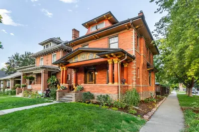 a red brick house with a black roof at 2 Mi to Downtown Denver Stylish Gem with Fireplace! in Denver