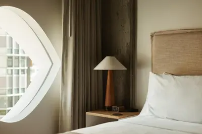 a bedroom with a bed and a lamp on a night stand at Populus in Denver