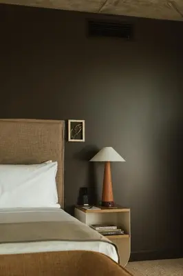 a bedroom with a bed and a lamp on a night stand at Populus in Denver