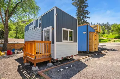 a tiny house sitting on a train track at Riverside Colorado in Bellvue