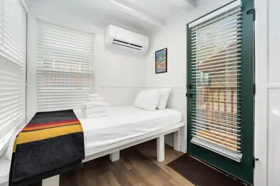 a small room with a bed and a window at Riverside Colorado in Bellvue