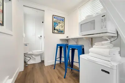 a kitchen with two blue stools and a microwave at Riverside Colorado in Bellvue