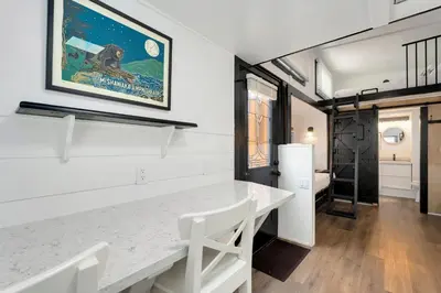 a kitchen with a white table and white chairs at Riverside Colorado in Bellvue