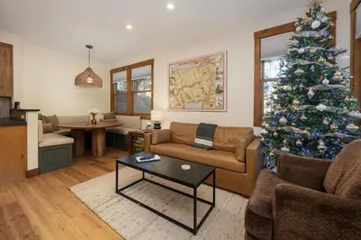 a living room with a christmas tree and a couch at Sundog Condo in Granby Ranch in Granby