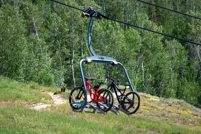 a bike is hanging from a ski lift at Sundog Condo in Granby Ranch in Granby