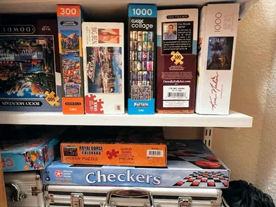 a shelf filled with board games and other games at Sundog Condo in Granby Ranch in Granby