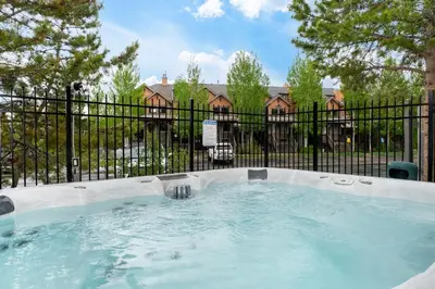 a hot tub in front of a fence at Sundog Condo in Granby Ranch in Granby